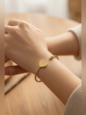 Kate Spade New York Heritage Spade Flex Cuff bracelet in a gold-tone finish.